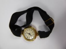 A Lady's Vintage 18 ct Gold Cocktail Watch, with black fabric strap.