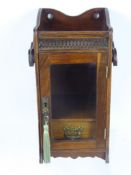 A Gentleman's Oak Smokers Cabinet, glazed fronted with single internal drawer and pipe rack, brass