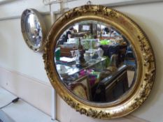 An Oval Gilt Wood Framed Hall Mirror, with decorative floral frame, bevelled glass. 59 x 67 cms