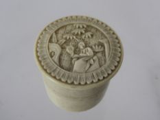 A Chinese Bone Miniature Canister and Cover, the cover carved with a figure seated in a garden,