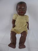 A Vintage British Porcelain Articulated Doll, with sleeping eyes, open mouth revealing small teeth.