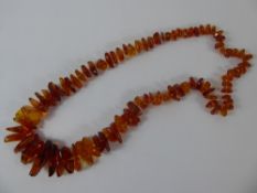 A Natural Amber Graduated Necklace, approx 76 cms in length.