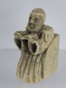 An Antique Stone Carving of a Franciscan Monk, depicted seated reading from the Bible, approx 10