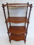 A Victorian Mahogany Display Stand, the stand having four scalloped edged shelves with turned