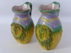 Two Majolica Rams Head Jugs, with cloven foot handles and rams head mask, approx 21 and 22 cms.