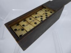 A Early 20th Century Bone and Ebony Dominoes Set, complete with playing pieces.