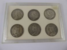 Six Silver Victorian Crowns, dated 1889,1890,1891,1895,1896 and 1900 in a perspex case, approx 168