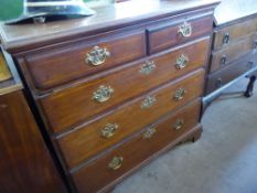 A Georgian Two-Piece Oak Chest of Drawers, two short with three long drawers, brass swan neck