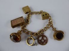 A Lady's Vintage 9ct Gold Charm Bracelet, with seven hallmarked gold charms, including church,