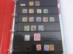 A Carrier Bag of Stamps; two Royal Mail Year Books (15 and 1999-Millennium) and two folders of