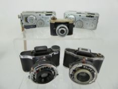 2 x Elgy Lumiere Cameras, Kunik Petie, 2 x Mamiya -16 Automatic.