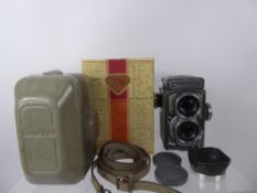 Rolleiflex 4 x 4 Camera, case, lens hood, strap and original box.