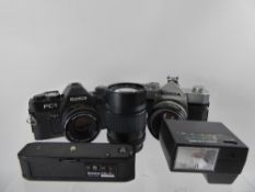 2 x Konica Auto Reflex Cameras, together with three lenses, 135mm F3.5, 52 mm F1.8, 50 mm F1.8