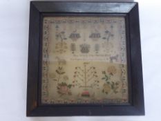 An Antique Sampler Depicting Flowers, Fruit, Trees, a Leopard and a Horse, embroidery reading "