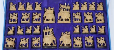 A Vintage Hand-Carved Indian Chess Set, the set having individual carved pieces depicting various