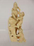 A 19th Century Japanese Ivory Okimono, shrine group depicting children clambering at the feet