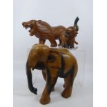 A Miscellaneous Collection of Carved Wooden Animals, including a lion approx 42 cms long, an