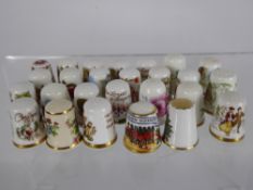 A Collection of Porcelain and Metal Commemorative Thimbles, in a large display case,
