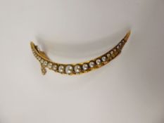 A Lady's Edwardian 14-15 ct Gold (tested) Seed Pearl Crescent Brooch, 4 - 1 mm, 50 mms and 6 gms.