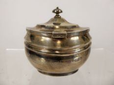 A Silver Oval Sugar/Tea Caddy, London hallmark, dated 1935, mm C S Harris & Sons, approx 166 gms.