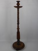 A Walnut Floor Candle Stand, approx 95 cms, turned column supported on a circular base.