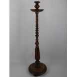 A Walnut Floor Candle Stand, approx 95 cms, turned column supported on a circular base.