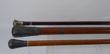 A 19th Century Swagger Stick, with decorative white metal top, together with vintage walking sticks.