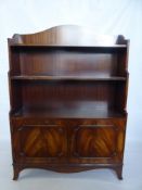 A Small Oak Waterfall Bookcase, with two cupboards beneath, approx 84 x 26 x 120 cms