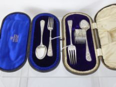 Two Silver Christening Sets, one comprising fork, spoon and napkin ring in the original box