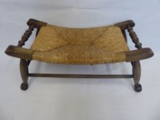 An Antique Oak Framed Rattan Stool, with swept design.