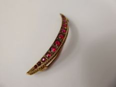 A Lady's Edwardian 9 ct Yellow Gold Ruby and Diamond Crescent Brooch, rubies 1.65 x 3.65 mm,