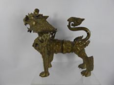 A Tibetan or Nepalese Brass Snow Lion, approx 34 x 32 cms.