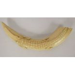 A Late 19th Century Congolese Ivory Tusk, carved crocodile to the top, approx 27 cms.