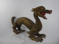 A Painted Wooden Figure of a Dragon, with a pearl of wisdom in its mouth, approx 54 x 28 cms.