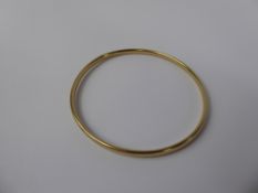 A Lady's 9 ct Yellow Gold Bangle, mm CBL, approx 14 gms