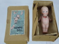 A Vintage KEWPIE Porcelain Doll, in original box.