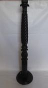 An Ebonised Carved Lamp Stand, with ribbon turned column, carved laurel base, approx 160 cms high.