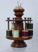 A Wood Turned Cotton Reel Holder, with fitted pin cushion finial, holds approx sixteen spools.