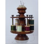 A Wood Turned Cotton Reel Holder, with fitted pin cushion finial, holds approx sixteen spools.