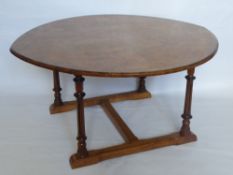 An Edwardian Walnut Top Coffee Table, the table on reeded supports with stretcher base, approx 89