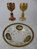 A Bohemian Glass Fruit Salad Bowl, with floral cartouche, together with two wine glasses one gold