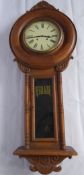 A Vintage American Style Pine Regulator Wall Clock, with white face, Roman numerals, carved