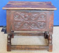 An Antique Wood-Carved Bible Box, raised on four turned legs and straight stretchers.