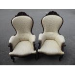 A Pair of Victorian Arm Chairs, with carving to arms and legs, serpentine fronted.