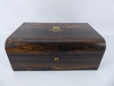 An Antique Dome-Topped Coromandel Wood Writing Box. The box inlaid with brass and having an
