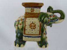 An Oriental Ceramic Green and Cream Decorative Elephant Plant Stand, (slight damage to edge of top
