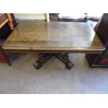 An Oak Coffee Table, with ornate central column on splayed feet, approx 116 x 67 x 49 cms.