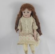 A German Catterfeld Puppenfabrik Bisque-Headed Doll, stitched leather body and legs, beautiful