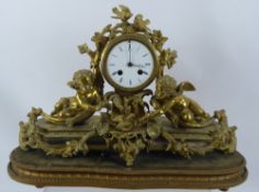 A French Bronze Gilt Mantel Clock, inset with painted porcelain panels, floral garland and two