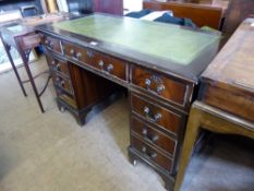 A Twin Pedestal Desk, tooled green leather top, centre drawer with four drawers either side,